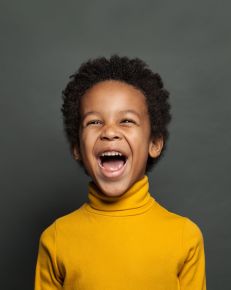 boy smiling dark background