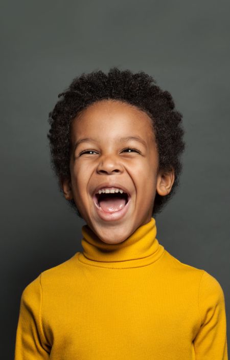 boy smiling dark background