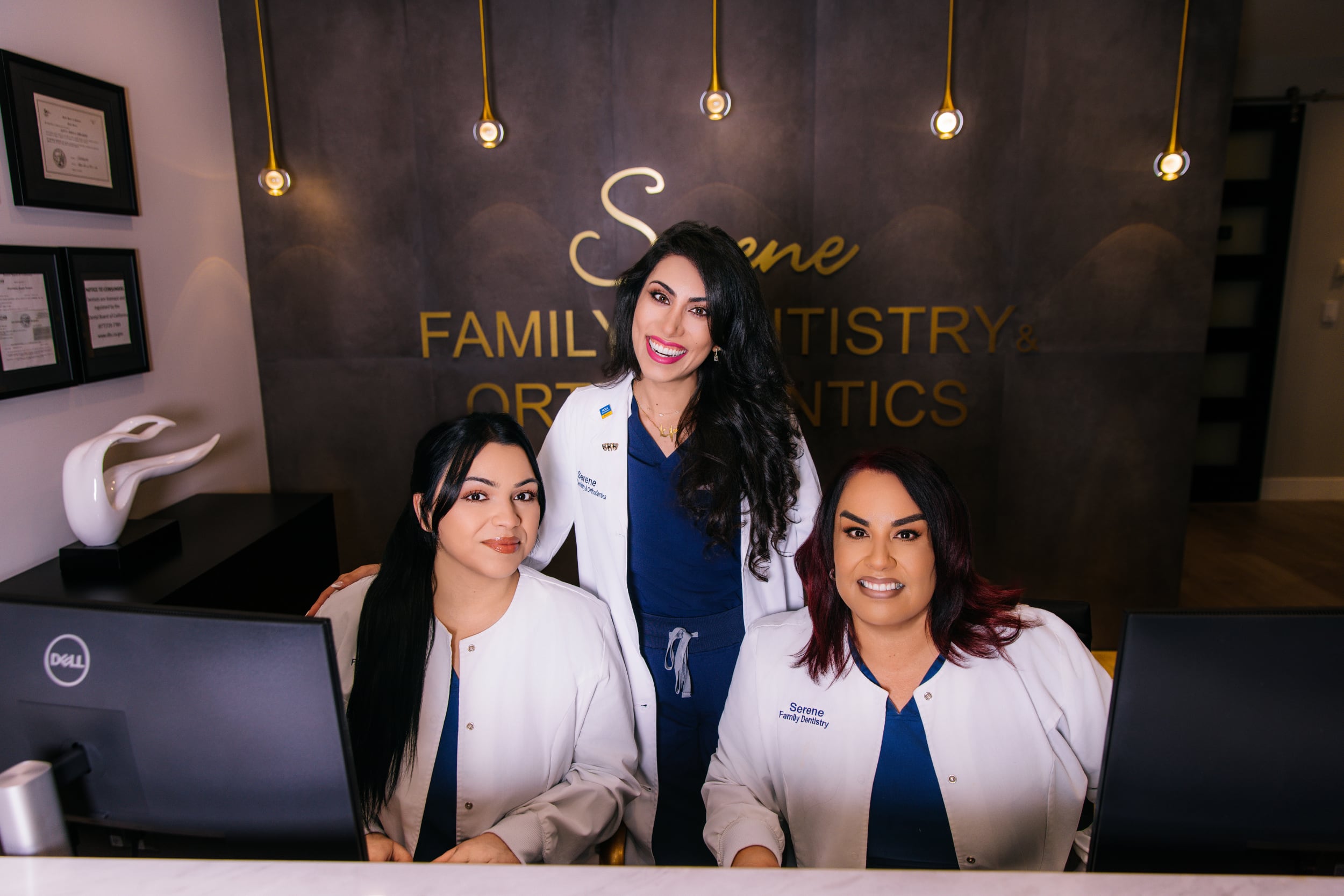 Serene Orthodontics Family Dentistry staff photo in office at front desk.