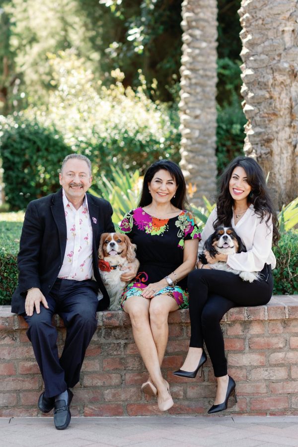 Portrait of Dr. Mana Naeim, with her dogs and parents.
